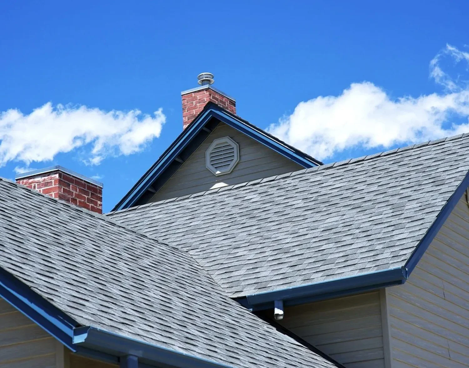 A house with a blue roof and a clock on the side.