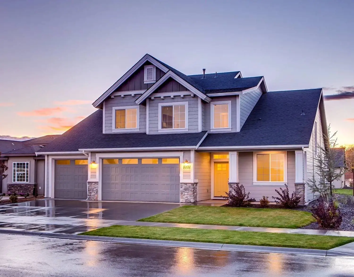 A house with a driveway and garage in front of it.